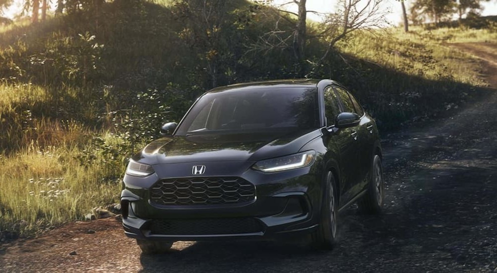 A gray 2027 Honda HR-V driving on a trail.