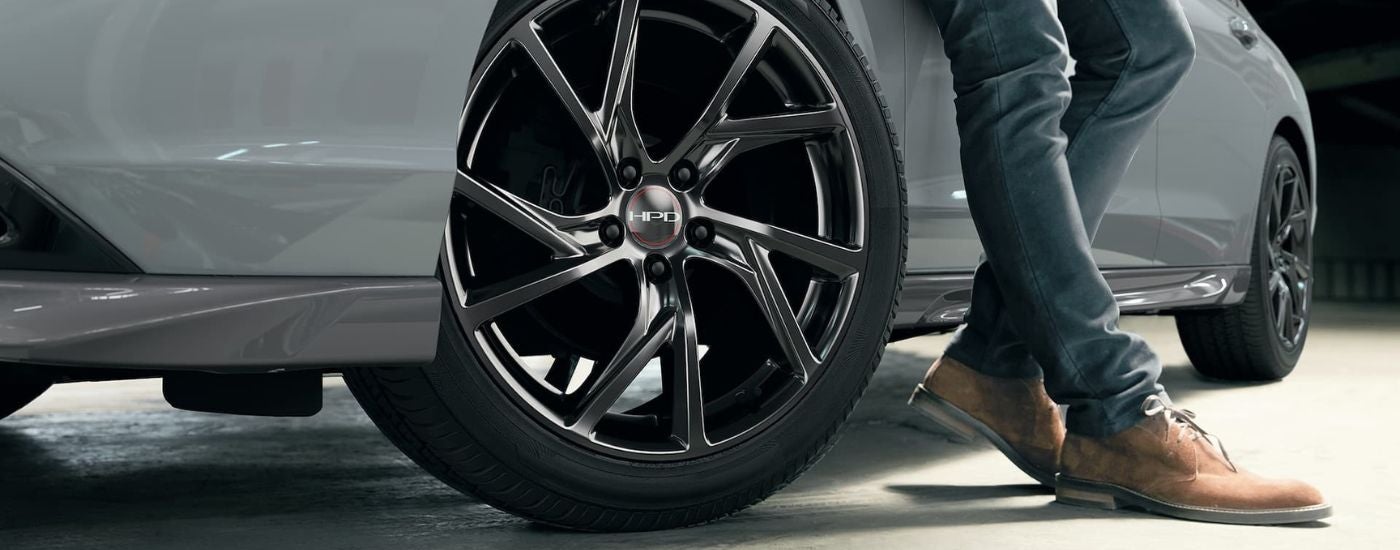 Close-up on the wheel of a grey 2026 Honda Accord Touring Hybrid.