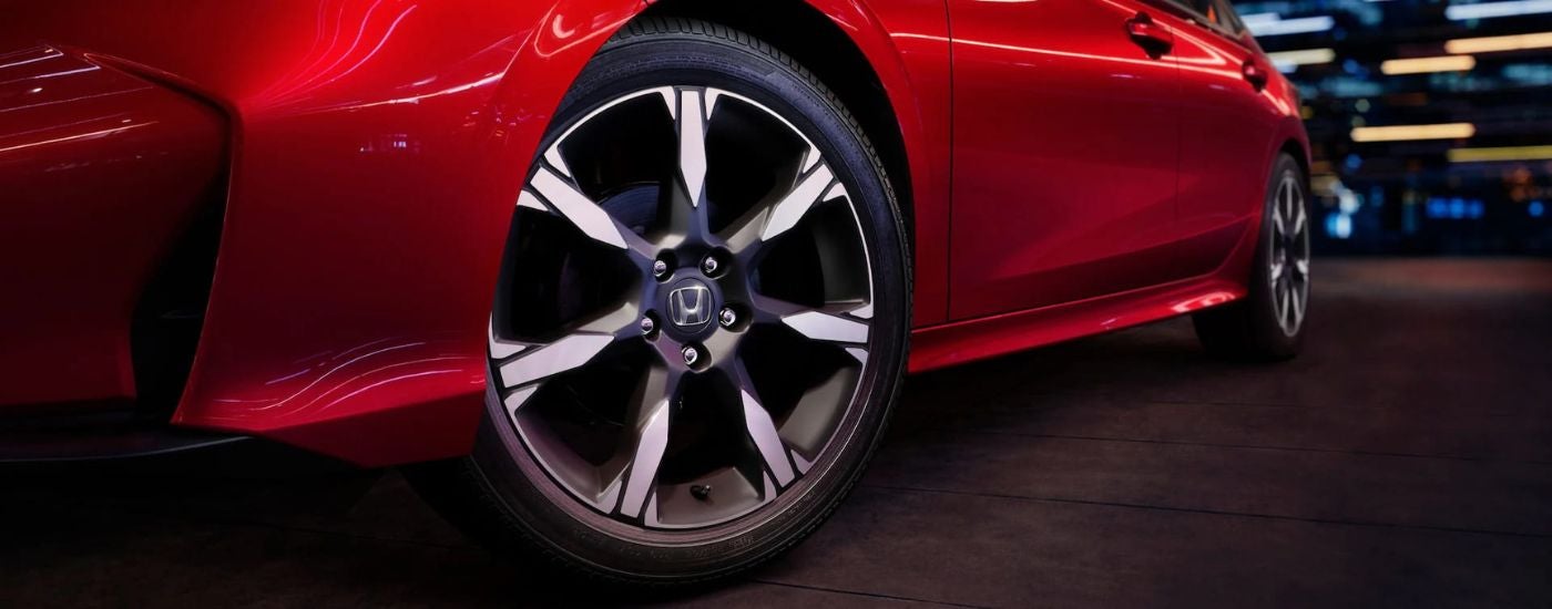 Close-up on the wheels of a red 2026 Honda Accord Hybrid.