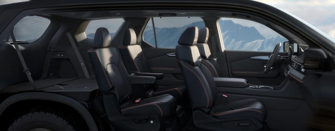 The black interior of a 2026 Honda Pilot from the side.