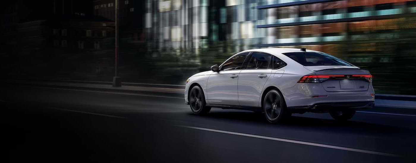 A white 2026 Honda Accord driving in a city.