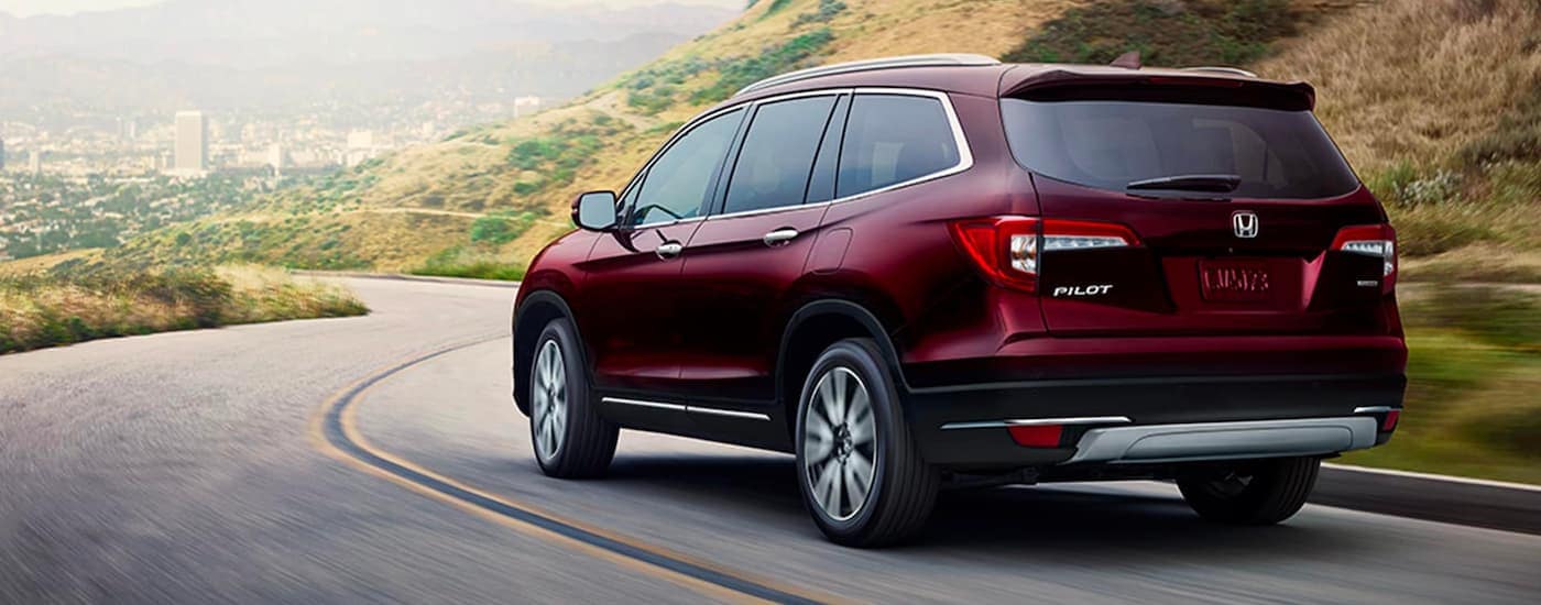 A red 2020 Honda Pilot from the rear.