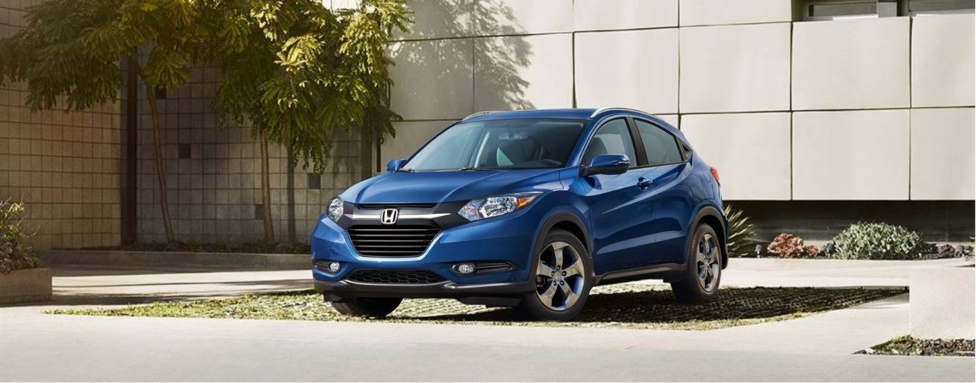Blue 2016 Honda HR-V parked in front of a wall