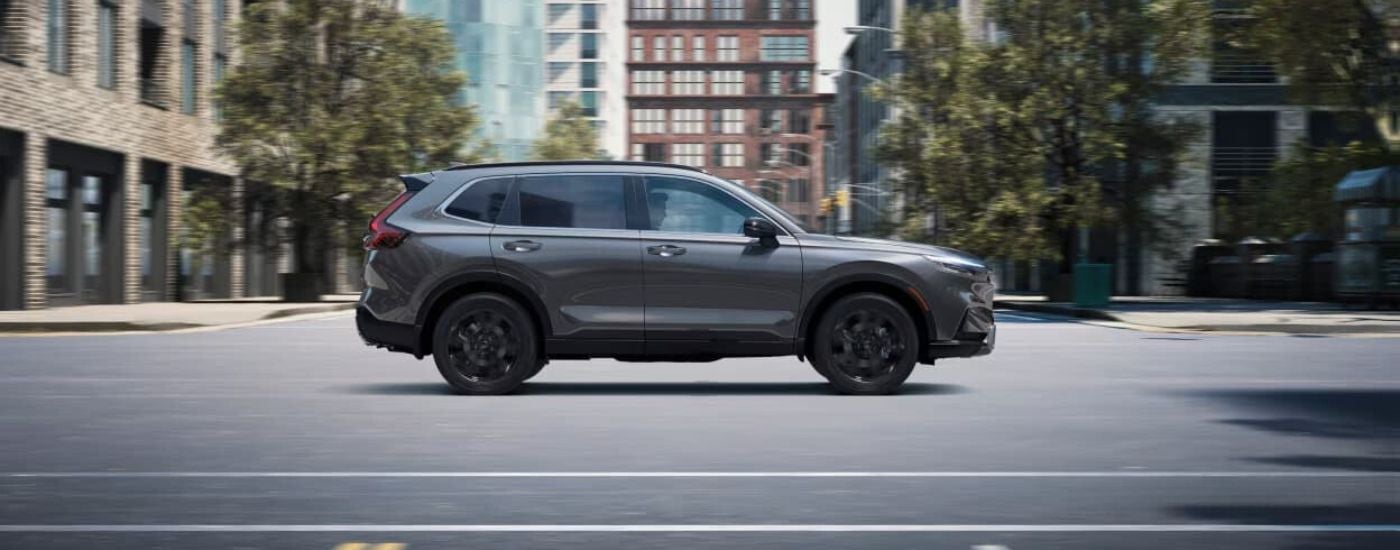 A gray 2024 Honda CR-V driving in a city